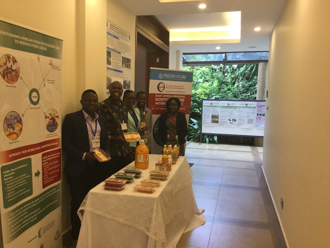 University of Nairobi team (Mr. Emmanuel Amwoka, Dr. Penina Yumbya and Prof. Jane Ambuko) pose with representatives from farmers groups (spokes) that have benefitted from their outreach programs